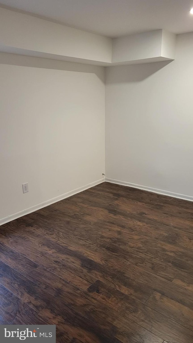 empty room with dark hardwood / wood-style floors