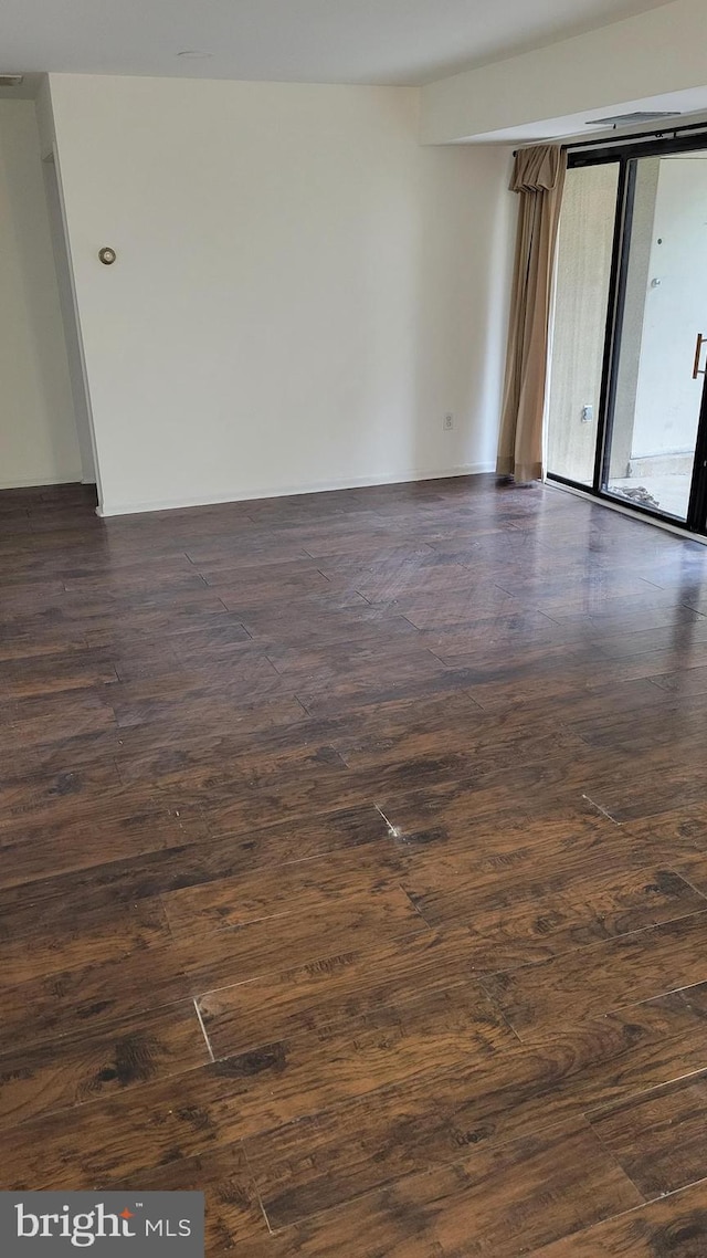 spare room featuring dark hardwood / wood-style floors