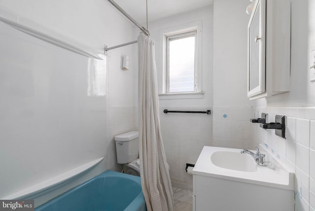 bathroom featuring vanity, tile walls, and shower / tub combo