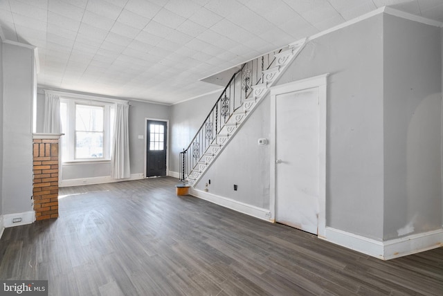 unfurnished living room with crown molding and dark hardwood / wood-style floors