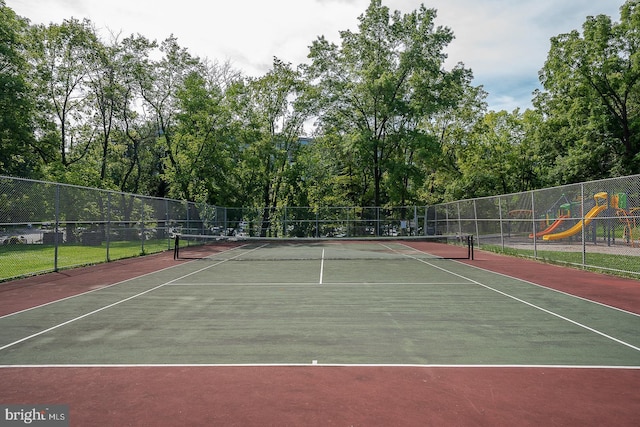 view of sport court with fence and playground community