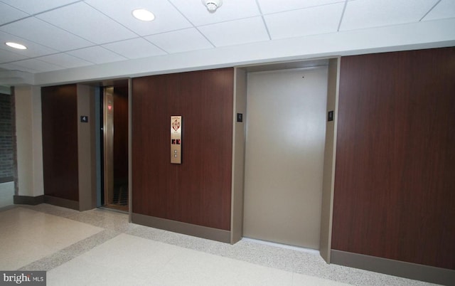 hallway featuring elevator, recessed lighting, speckled floor, and a drop ceiling