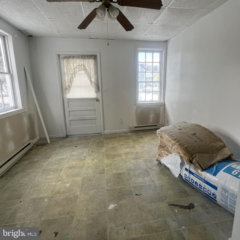 foyer entrance featuring a baseboard radiator and a paneled ceiling