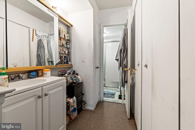 bathroom featuring vanity and an enclosed shower