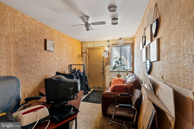 carpeted home office featuring ceiling fan