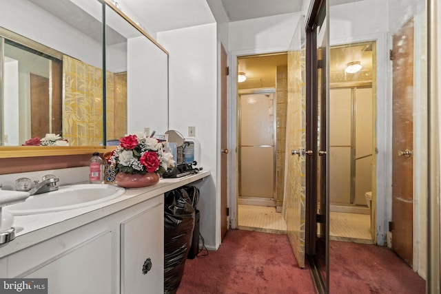 bathroom featuring vanity and a shower with door