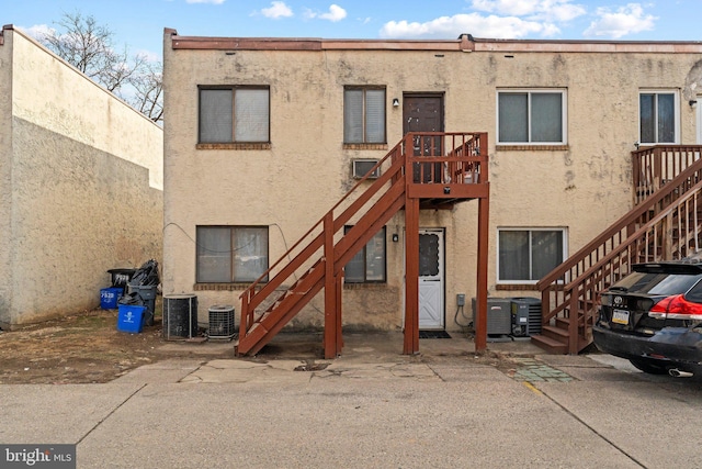 rear view of property featuring cooling unit