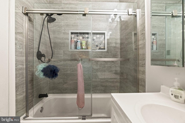 bathroom featuring vanity and combined bath / shower with glass door