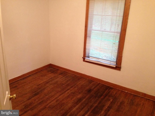 empty room with hardwood / wood-style flooring