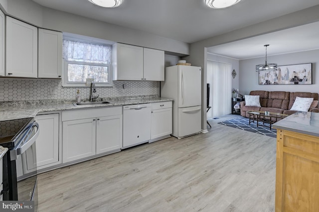 kitchen with pendant lighting, sink, white appliances, and white cabinets