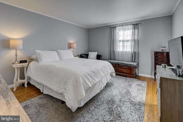 bedroom with ornamental molding and wood-type flooring