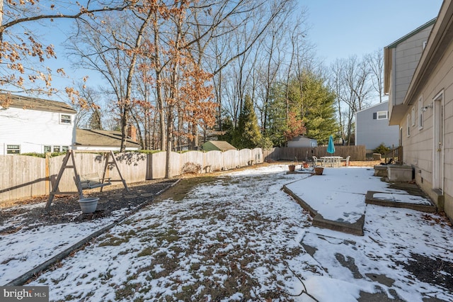 view of yard layered in snow