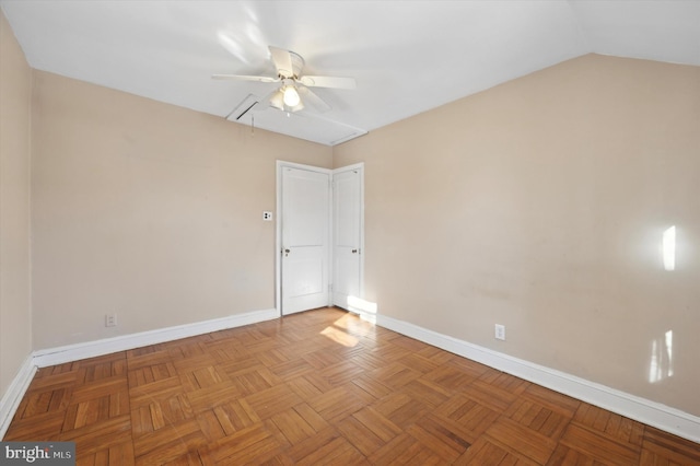 spare room with ceiling fan, light parquet flooring, and lofted ceiling