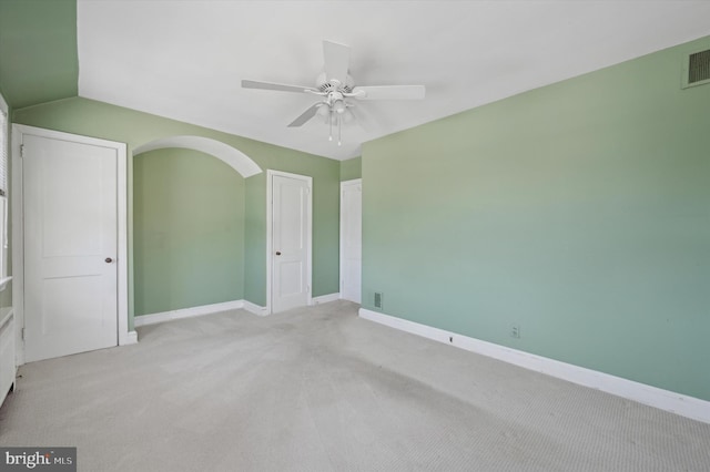 unfurnished room with ceiling fan, light colored carpet, and lofted ceiling