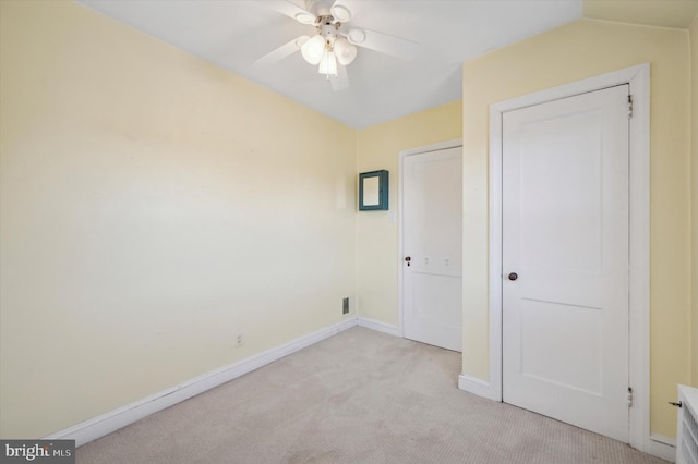 unfurnished bedroom featuring light carpet and ceiling fan