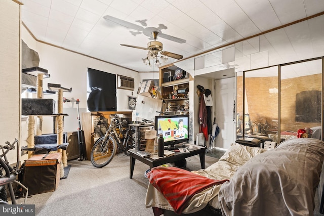 carpeted living room featuring ornamental molding and ceiling fan