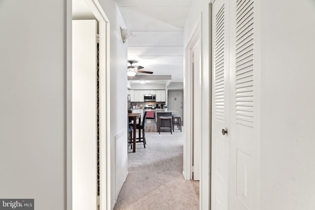 corridor featuring light carpet