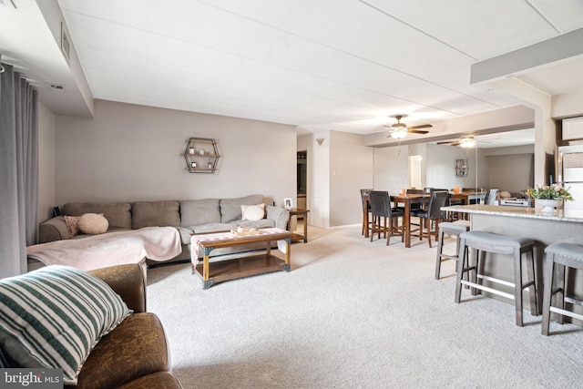 carpeted living room featuring ceiling fan