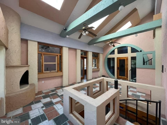 view of patio / terrace featuring ceiling fan and a fireplace