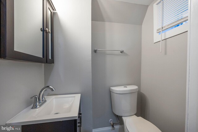 half bathroom with vanity and toilet