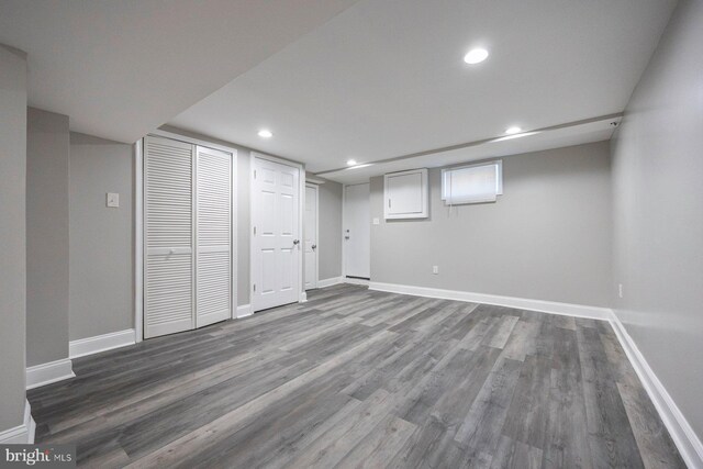 basement with baseboards, wood finished floors, and recessed lighting