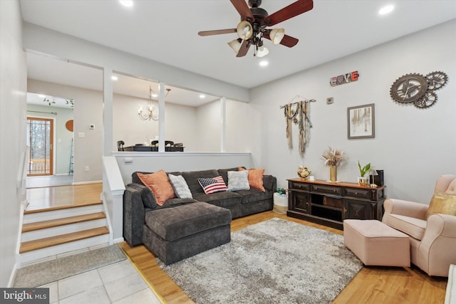 living area featuring ceiling fan with notable chandelier, recessed lighting, and wood finished floors