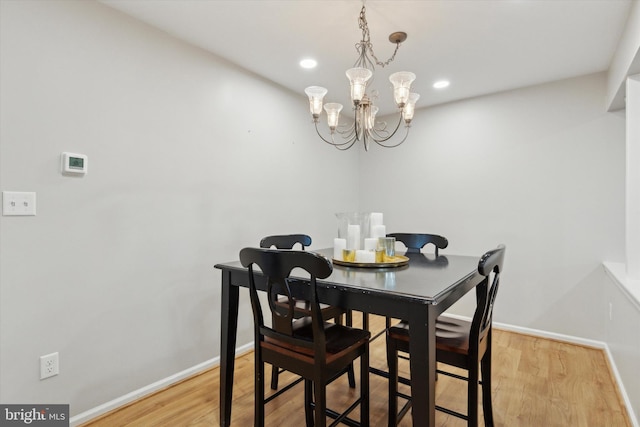 dining area featuring light wood-type flooring, baseboards, a chandelier, and recessed lighting