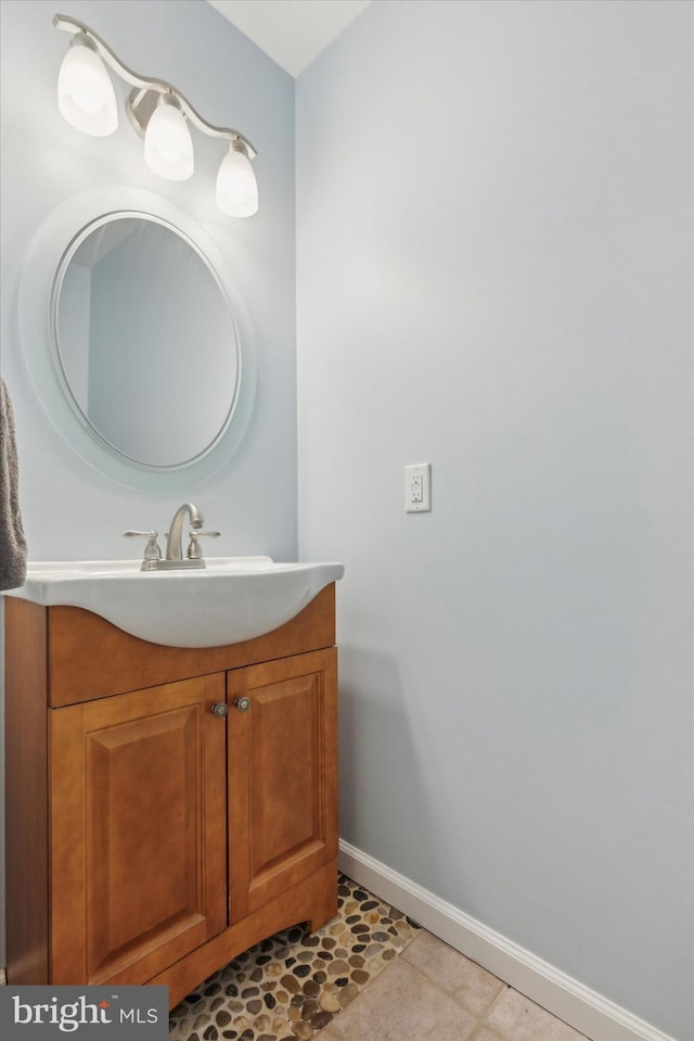 bathroom with tile patterned flooring, vanity, and baseboards