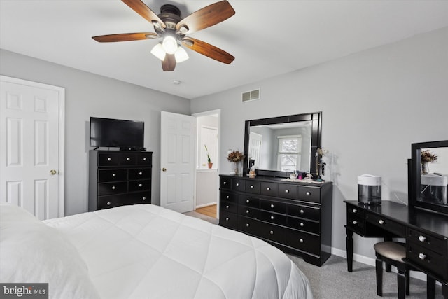 bedroom with light carpet, baseboards, visible vents, and ceiling fan