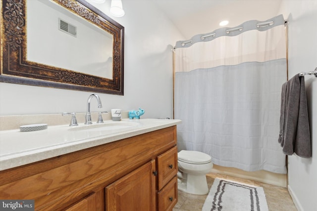 bathroom with visible vents, vanity, toilet, and tile patterned floors