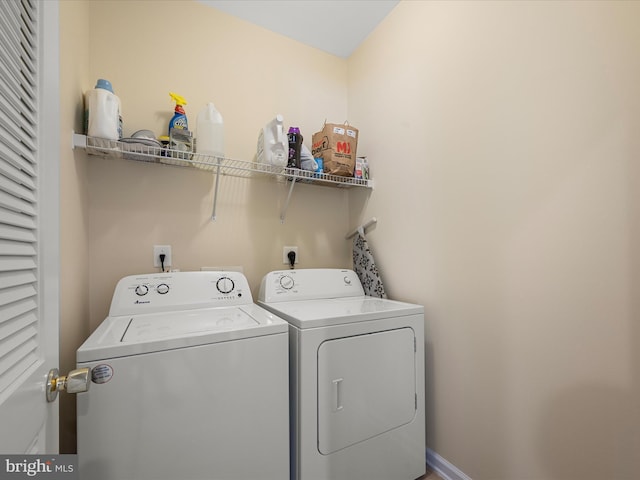 clothes washing area featuring washer and clothes dryer