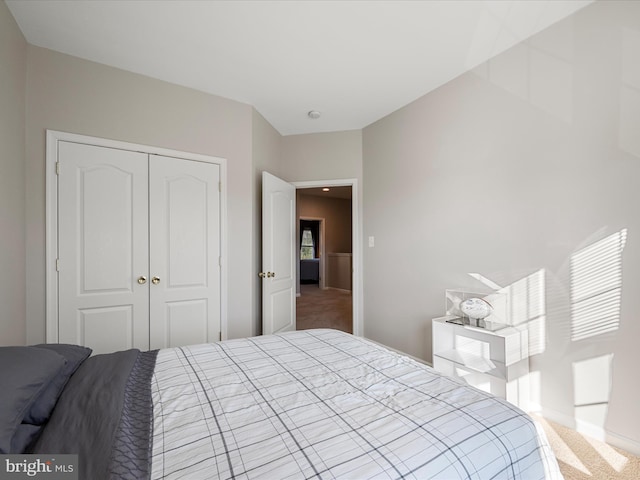 carpeted bedroom with a closet