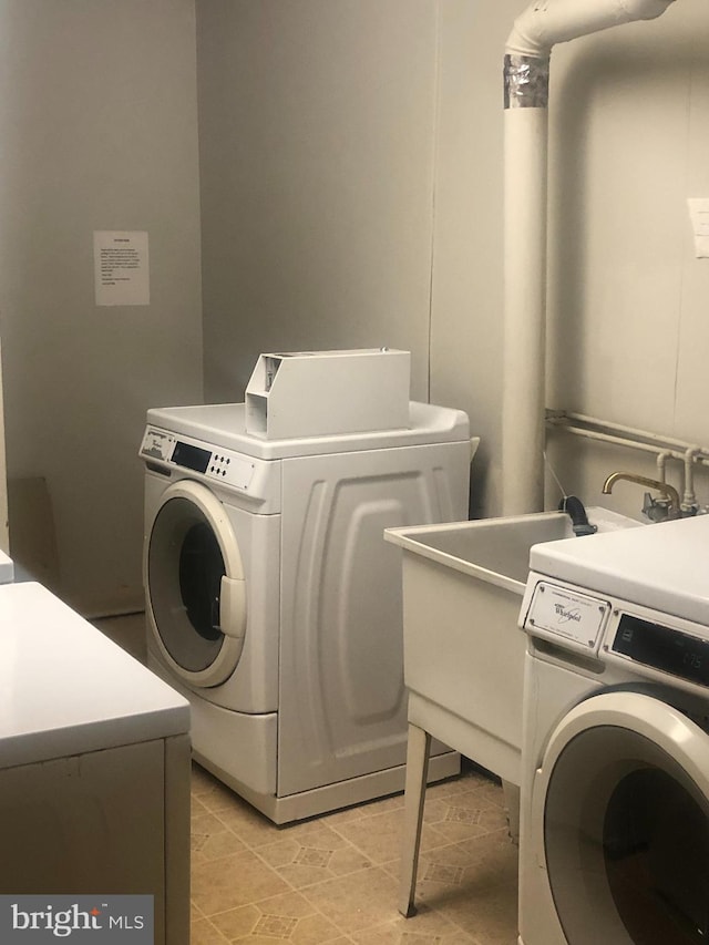 laundry area featuring washing machine and clothes dryer