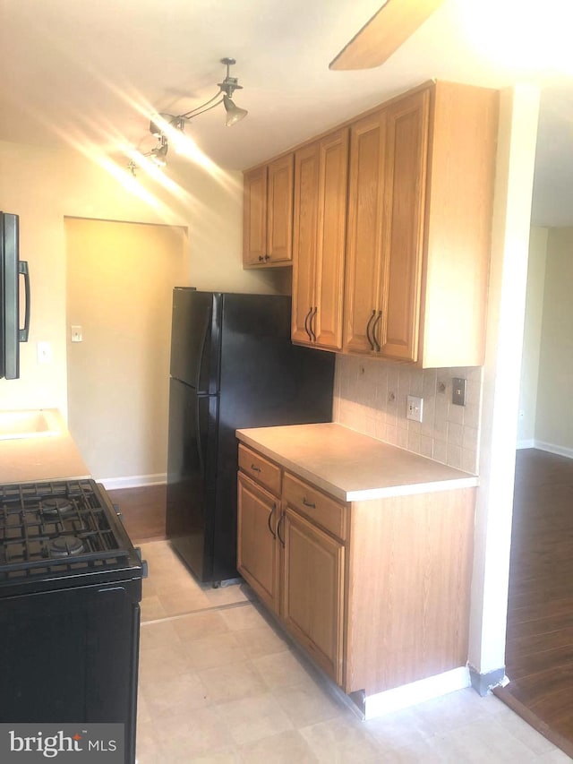 kitchen with tasteful backsplash and black appliances