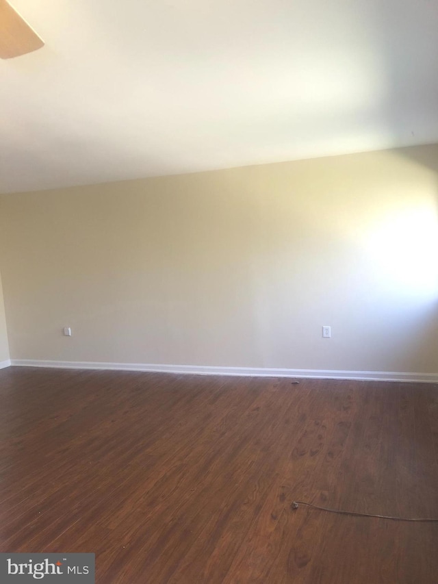 spare room featuring dark hardwood / wood-style flooring