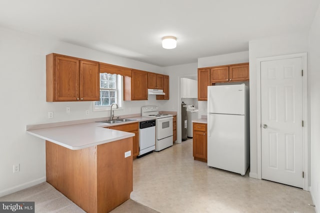 kitchen featuring sink, white appliances, washer / clothes dryer, and kitchen peninsula