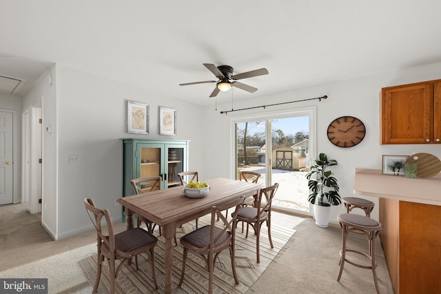 carpeted dining space featuring ceiling fan