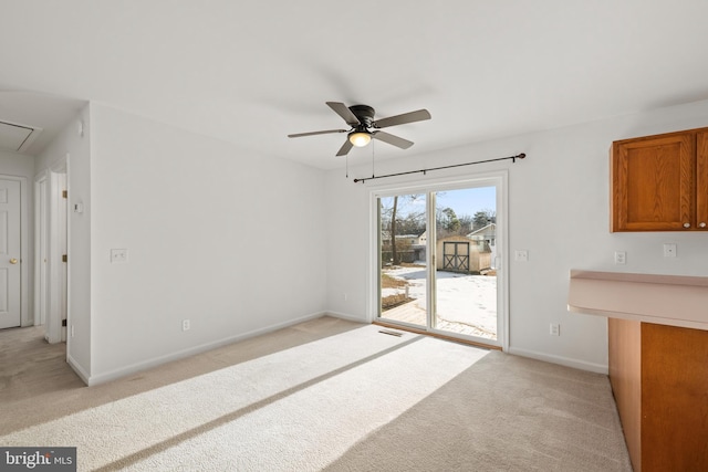 unfurnished living room featuring light colored carpet and ceiling fan