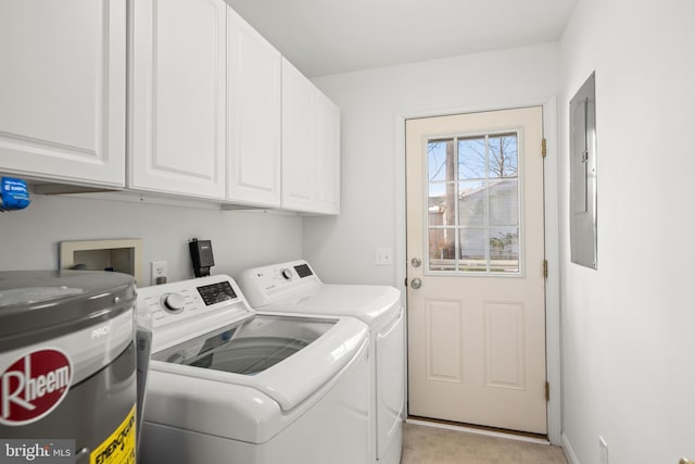 clothes washing area featuring independent washer and dryer, cabinets, and electric water heater