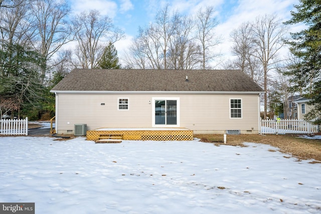 snow covered rear of property with central AC