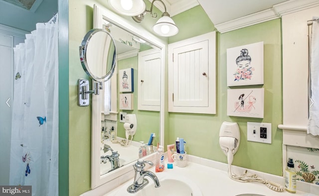 bathroom with crown molding, vanity, and a shower with shower curtain