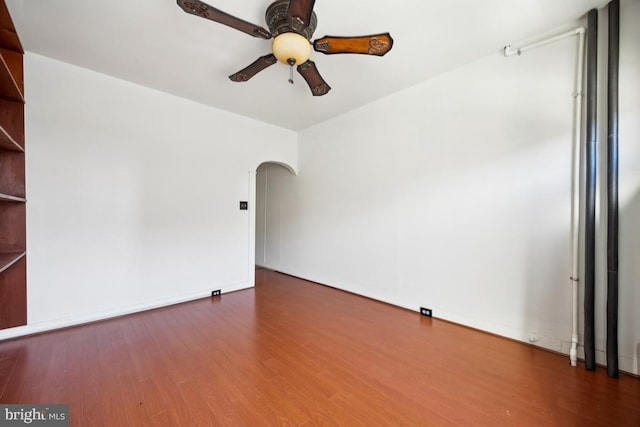 spare room featuring ceiling fan and dark hardwood / wood-style flooring