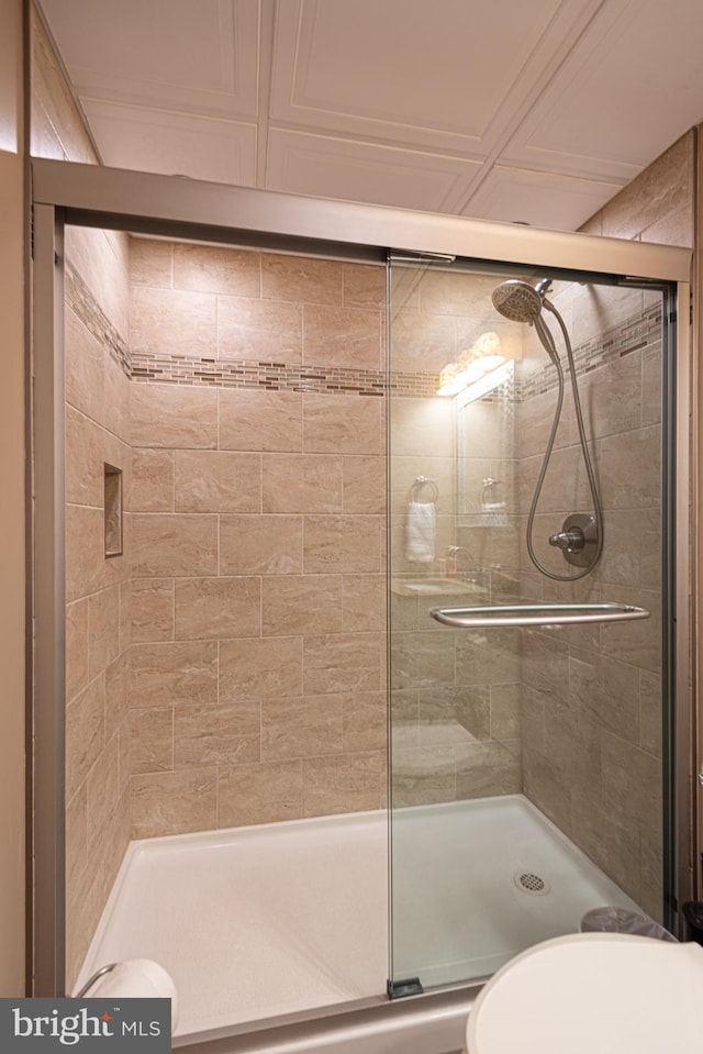 bathroom with a shower with door