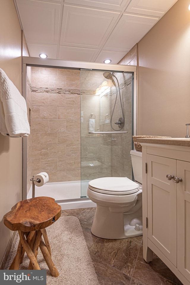 bathroom with an enclosed shower, vanity, and toilet