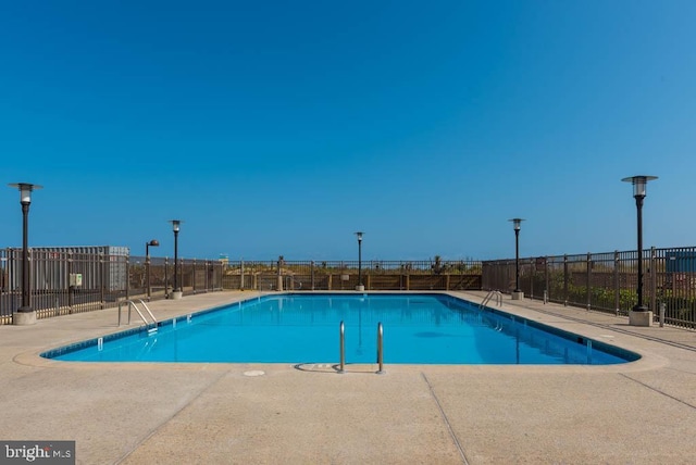 view of swimming pool with a patio