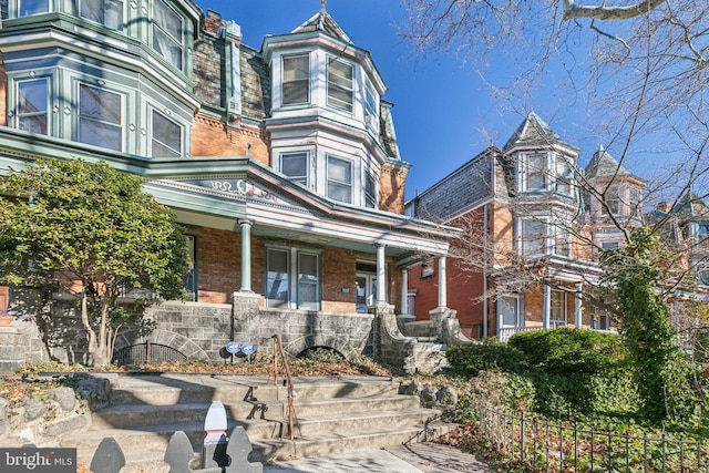 victorian house featuring a porch