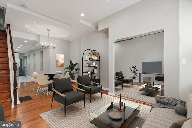 living room featuring light hardwood / wood-style floors and a chandelier