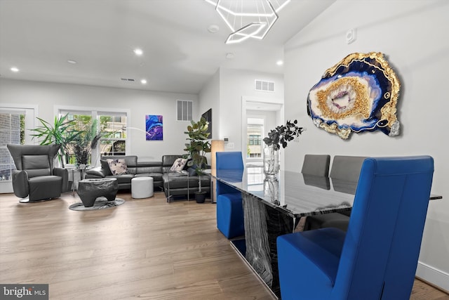 dining space featuring an inviting chandelier, hardwood / wood-style floors, and a wealth of natural light