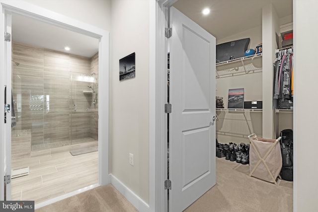 bathroom featuring a shower with door