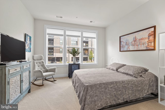 bedroom featuring light carpet